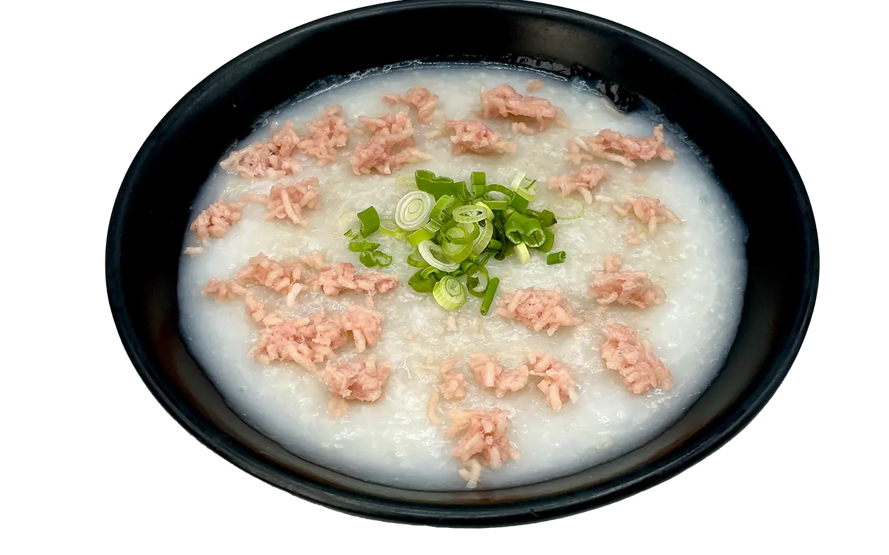 Smooth minced pork congee garnished with fresh chopped green onions at E Noodle Chinatown, a Chinese Restaurant in New York